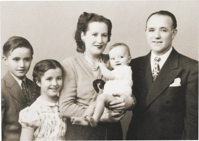 A black and white photo of a family.