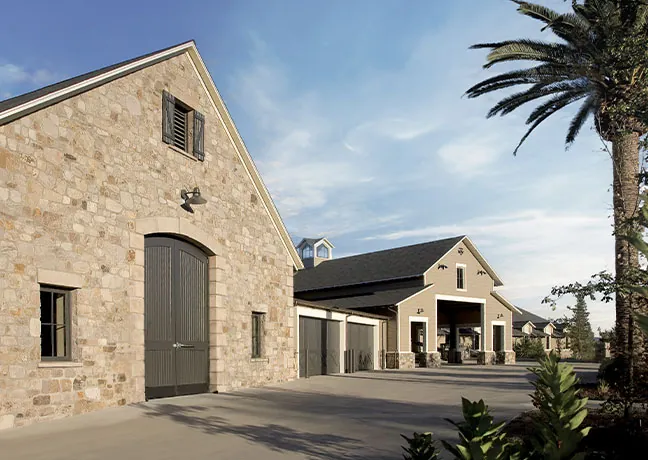 A stone building with a palm tree in front of it.