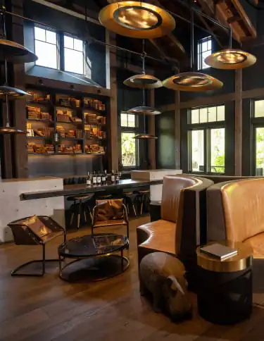 A living room with a large wooden table and chairs.