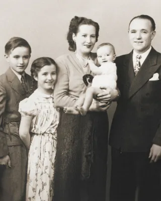 A black and white photo of a family posing for a picture.