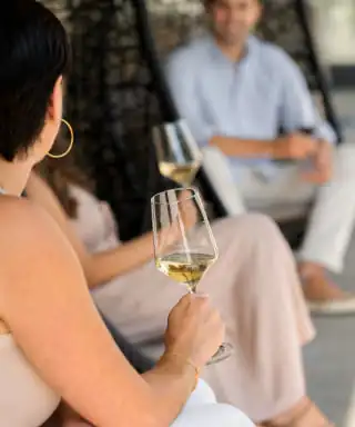 A woman holding a glass of wine.