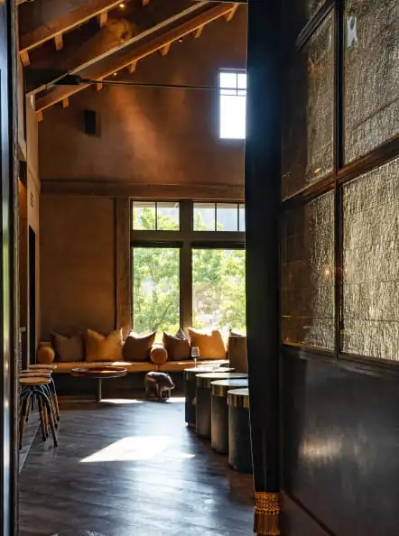 A room with a wooden floor and large windows.