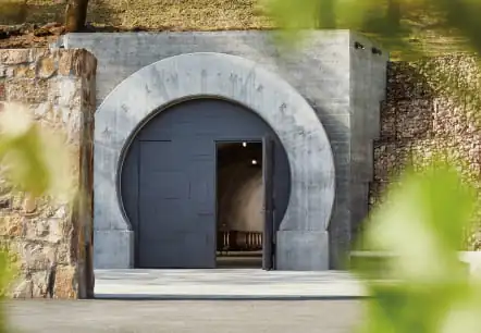 The entrance to a wine cellar with an archway.